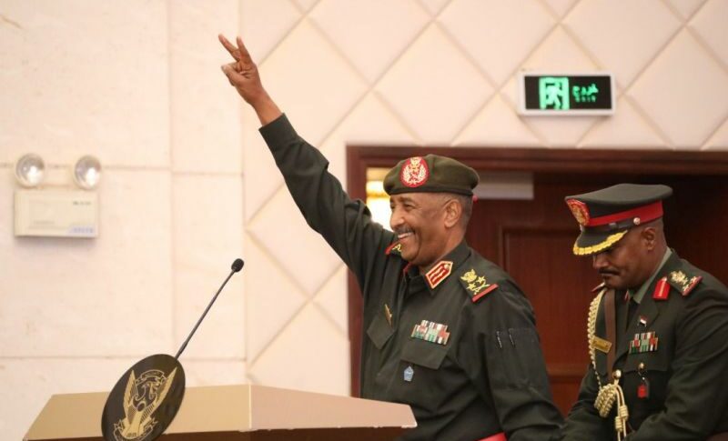 Al-Burha-gives-Victory-sign-before-to-speak-at-the-signing-ceremony-of-the-Political-Framework-Agreement-on-December-5-2022