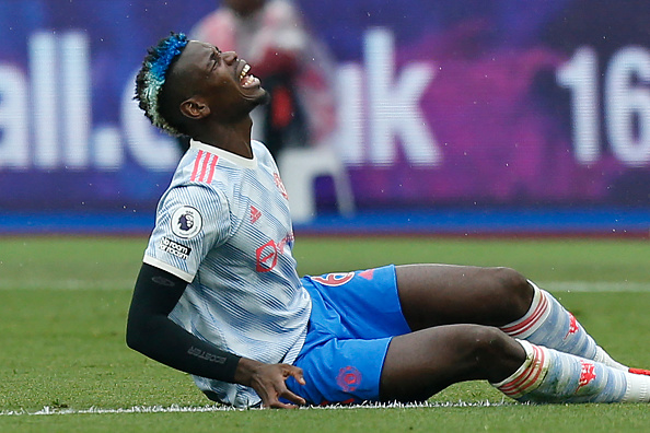 Manchester United's French midfielder Paul Pogba reacts after picking up an injury during the English Premier League football match between West Ham United and Manchester United at The London Stadium, in east London on September 19, 2021. - RESTRICTED TO EDITORIAL USE. No use with unauthorized audio, video, data, fixture lists, club/league logos or 'live' services. Online in-match use limited to 120 images. An additional 40 images may be used in extra time. No video emulation. Social media in-match use limited to 120 images. An additional 40 images may be used in extra time. No use in betting publications, games or single club/league/player publications. (Photo by Ian KINGTON / AFP) / RESTRICTED TO EDITORIAL USE. No use with unauthorized audio, video, data, fixture lists, club/league logos or 'live' services. Online in-match use limited to 120 images. An additional 40 images may be used in extra time. No video emulation. Social media in-match use limited to 120 images. An additional 40 images may be used in extra time. No use in betting publications, games or single club/league/player publications. / RESTRICTED TO EDITORIAL USE. No use with unauthorized audio, video, data, fixture lists, club/league logos or 'live' services. Online in-match use limited to 120 images. An additional 40 images may be used in extra time. No video emulation. Social media in-match use limited to 120 images. An additional 40 images may be used in extra time. No use in betting publications, games or single club/league/player publications. (Photo by IAN KINGTON/AFP via Getty Images)